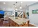 Open kitchen with granite island, pendant lighting, and seamless flow to the living area at 583 S York St, Denver, CO 80209