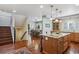 Open kitchen area with hardwood floors, granite counters, and access to the dining room and staircase at 583 S York St, Denver, CO 80209
