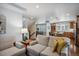 Open concept living room showcasing hardwood floors, cozy seating, and a view to the kitchen at 583 S York St, Denver, CO 80209