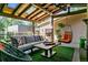 Relaxing outdoor patio with comfortable seating, a cozy hanging chair, and stylish decor under a charming pergola at 583 S York St, Denver, CO 80209
