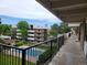 Exterior view from walkway showing common green area and pool at 384 S Ironton St # 407, Aurora, CO 80012