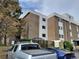Exterior of an apartment complex with dedicated visitor parking, and a natural green space at 384 S Ironton St # 407, Aurora, CO 80012