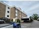 Apartment complex exterior featuring covered parking and handicap parking spaces on a cloudy day at 384 S Ironton St # 407, Aurora, CO 80012