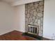 Living room featuring a stone fireplace and wood-style floors at 384 S Ironton St # 407, Aurora, CO 80012