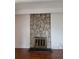 Living room with stone fireplace, gleaming hardwood floors at 384 S Ironton St # 407, Aurora, CO 80012