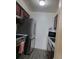 Well-equipped kitchen with stainless steel fridge, dark wood cabinets and gray flooring at 384 S Ironton St # 407, Aurora, CO 80012