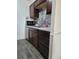Modern kitchen with stainless steel appliances, dark wood cabinets and gray backsplash at 384 S Ironton St # 407, Aurora, CO 80012