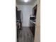 Well-equipped kitchen with stainless steel fridge, dark wood cabinets and gray flooring at 384 S Ironton St # 407, Aurora, CO 80012