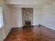 Spacious living room with stone fireplace and gleaming hardwood floors at 384 S Ironton St # 407, Aurora, CO 80012