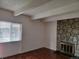 Living room with stone fireplace, gleaming hardwood floors and abundant light at 384 S Ironton St # 407, Aurora, CO 80012