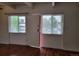 A bright living room featuring hardwood floors and two windows at 384 S Ironton St # 407, Aurora, CO 80012