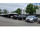 Outdoor parking lot with covered parking and mature trees surrounding the apartment complex at 384 S Ironton St # 407, Aurora, CO 80012