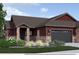 Charming exterior features stone accents, a covered entry, and a two-car garage, creating inviting curb appeal at 862 W 129Th Pl, Westminster, CO 80234