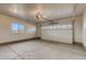 Spacious garage with overhead door, window, and ample room for parking and storage, enhancing home convenience at 862 W 129Th Pl, Westminster, CO 80234