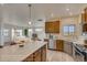 Well-designed kitchen with stainless steel appliances, a center island, and open access to the living area at 862 W 129Th Pl, Westminster, CO 80234