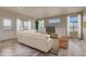 Spacious living room featuring large windows, comfortable seating, and plenty of natural light at 862 W 129Th Pl, Westminster, CO 80234
