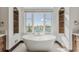 The spa-like bathroom features a large soaking tub under a picture window with views of the water at 1820 Mallard Dr, Broomfield, CO 80020