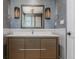 Stylish bathroom with framed mirror, modern vanity lighting, and textured wallpaper at 1820 Mallard Dr, Broomfield, CO 80020