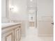 Bright bathroom with custom vanity, hexagon tile flooring, and tiled walls at 1820 Mallard Dr, Broomfield, CO 80020