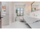 Bright powder room featuring a modern floating vanity, elegant fixtures, and a large window with greenery views at 1820 Mallard Dr, Broomfield, CO 80020