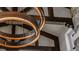 Close-up view of rustic round chandelier with exposed wood beams providing a unique touch to the home at 1820 Mallard Dr, Broomfield, CO 80020