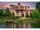 Waterfront home with manicured lawn and lakeside dock offering scenic views from multiple balconies at 1820 Mallard Dr, Broomfield, CO 80020