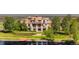 Luxury home featuring lush landscaping, a dock, and expansive lawn overlooking a serene lake at 1820 Mallard Dr, Broomfield, CO 80020