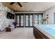 Hot tub room with stone accent wall, wood-paneled ceiling and tile flooring at 1820 Mallard Dr, Broomfield, CO 80020