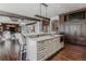 Open-concept kitchen features island seating, custom cabinetry, and hardwood floors at 1820 Mallard Dr, Broomfield, CO 80020