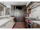 Chef's kitchen featuring stainless appliances, custom cabinets, a large island, and hardwood floors at 1820 Mallard Dr, Broomfield, CO 80020