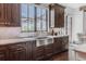 Kitchen sink area with custom cabinets, stainless steel sink, and view out to the patio at 1820 Mallard Dr, Broomfield, CO 80020