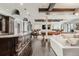 Open-concept living area with wet bar, wooden beams, hardwood floors and a billiards table at 1820 Mallard Dr, Broomfield, CO 80020