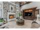 Elegant living room features a stone fireplace, custom built-ins, and a unique round coffee table at 1820 Mallard Dr, Broomfield, CO 80020