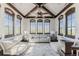 Bright living room with vaulted wood-beam ceiling, arched windows and comfortable seating at 1820 Mallard Dr, Broomfield, CO 80020