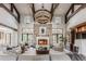 Spacious living room with fireplace, stone accent wall, high ceilings, and ample natural light at 1820 Mallard Dr, Broomfield, CO 80020
