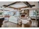 Elegant living room with stone fireplace, wooden beam ceilings and hardwood floors at 1820 Mallard Dr, Broomfield, CO 80020