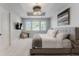 Well-lit main bedroom featuring a tray ceiling, plush carpet and a wall-mounted television at 1820 Mallard Dr, Broomfield, CO 80020
