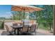 Outdoor kitchen featuring a built-in grill, dining table and umbrella at 1820 Mallard Dr, Broomfield, CO 80020