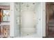 A glass enclosed shower features gold hardware, a built-in bench, and tiled walls at 1820 Mallard Dr, Broomfield, CO 80020