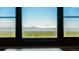 Stunning mountain views are framed by a large window in this exquisite home at 1820 Mallard Dr, Broomfield, CO 80020