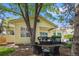 Charming backyard with a lush lawn, mature trees, and a dark deck perfect for relaxing or entertaining at 7638 S Hudson Way, Centennial, CO 80122