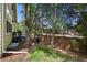 Serene backyard featuring mature trees, a cozy seating area, and a wood fence at 7638 S Hudson Way, Centennial, CO 80122