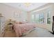 Bright bedroom featuring large windows, a ceiling fan, and neutral decor at 7638 S Hudson Way, Centennial, CO 80122