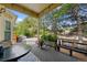 Inviting covered patio featuring comfortable seating, a grill, and scenic backyard views for outdoor enjoyment at 7638 S Hudson Way, Centennial, CO 80122