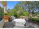 Spacious deck with a grill, comfortable seating, and beautiful landscaping offers an ideal space for outdoor living at 7638 S Hudson Way, Centennial, CO 80122