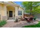 Inviting front patio with comfortable seating and a cozy fire pit, perfect for outdoor relaxation at 7638 S Hudson Way, Centennial, CO 80122