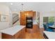 Kitchen with wood cabinets, an island, and stainless-steel double oven appliance set at 7638 S Hudson Way, Centennial, CO 80122