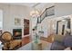 Open-concept living room with a fireplace, staircase, hardwood floors, and natural light at 7638 S Hudson Way, Centennial, CO 80122