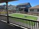 Backyard view from the covered patio, showcasing manicured lawn and a fire pit at 22822 E Union Cir, Aurora, CO 80015