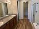 Bathroom with double vanity, granite countertop, shower, separate toilet room, and walk-in closet at 22822 E Union Cir, Aurora, CO 80015